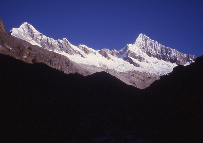 The first view of Alpamayo and Quitaraju from the approach trek in Quebrada Santa Cruz