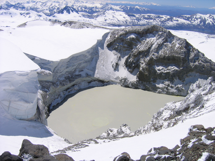 The spectacular crater on the east side fo Copahue. The lake is full of sulphur and steams away, 
the ice cliff at the edge of the glacier is ove 100m high and overhangs by about 10?.
